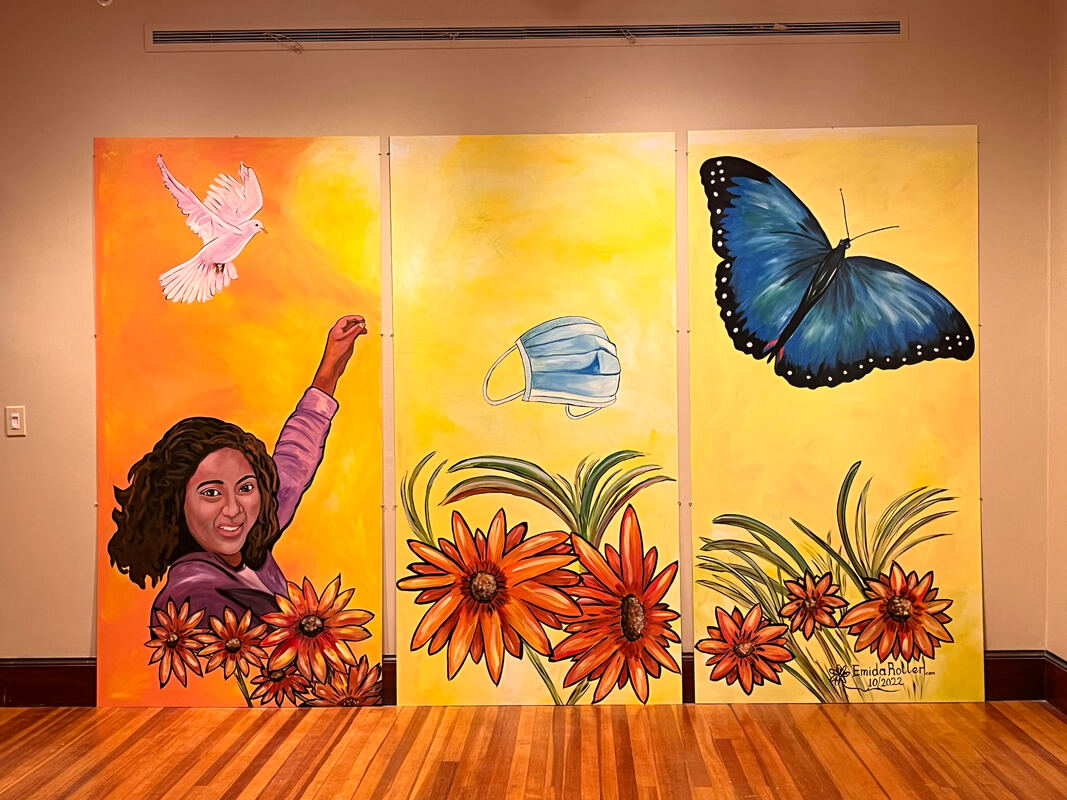 A 3-panel wall mural by Emida Roller featuring butterlies, a bird, and a Black woman tossing a surgical mask into the sky.