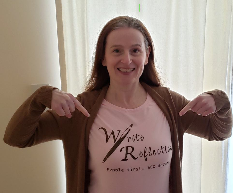 Photo of Shari Berg, owner of The Write Refletion, wearing a branded business shirt. 