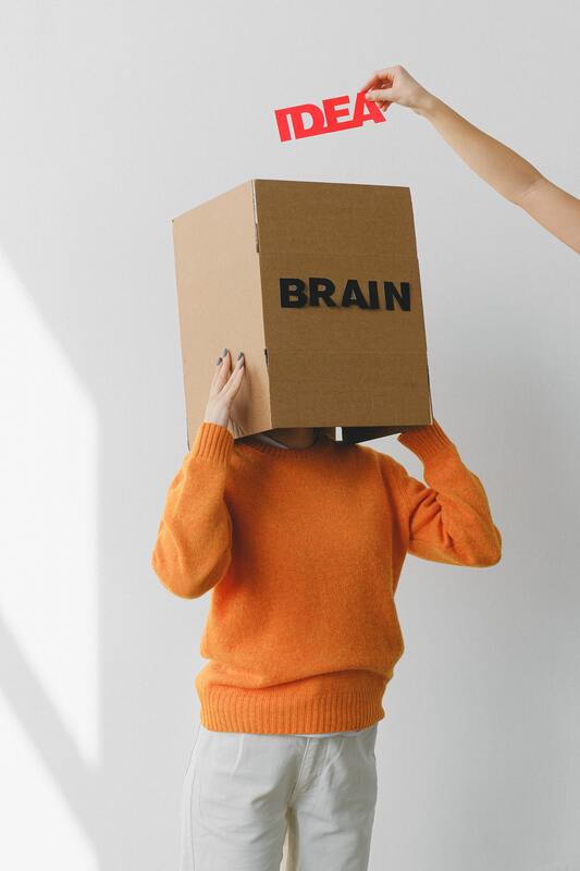 Photo of person with box over their head that says 
