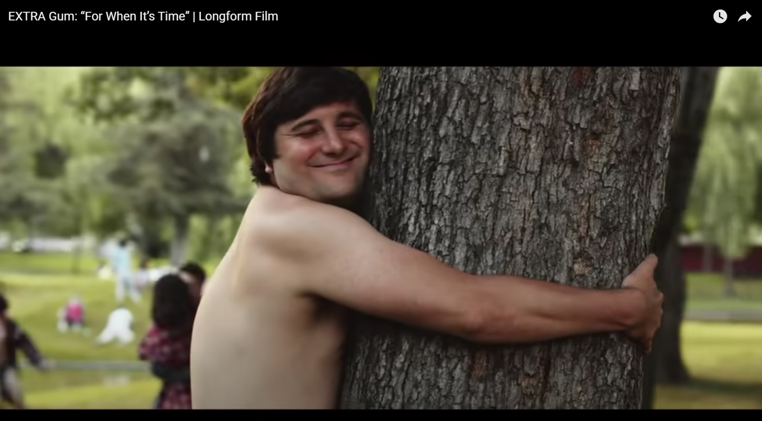 Screenshot of a man hugging a tree from an Extra Gum commercial. 