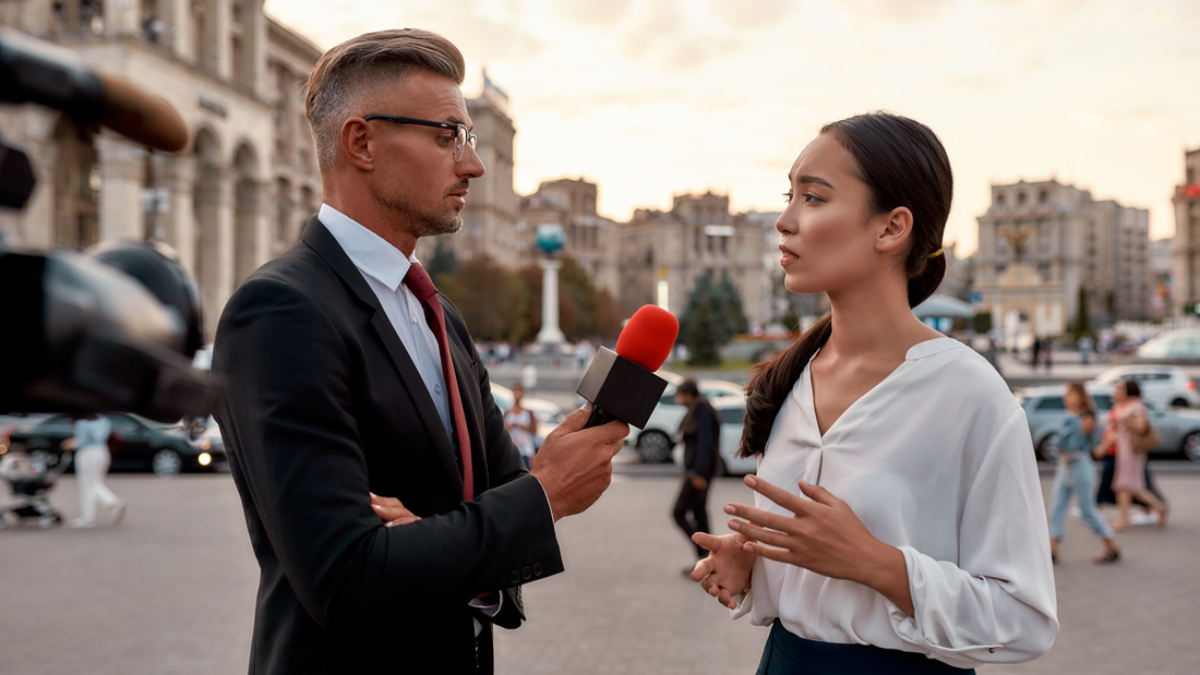TV reporter interviewing a woman on the street. 