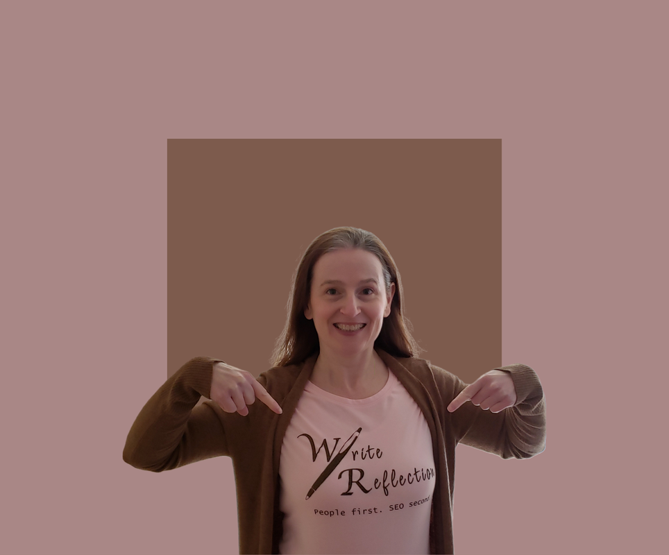 Shari Berg of The Write Reflection pointing to a branded shirt that says 