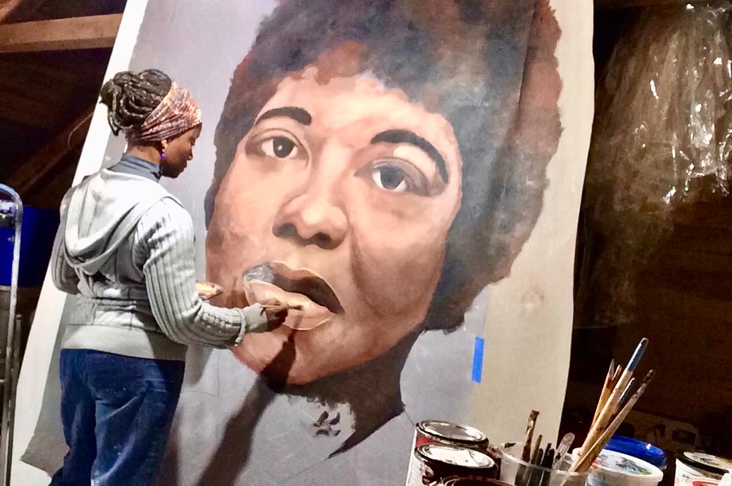 Emida Roller Productions artist Emida Roller works on a mural for one of her clients.